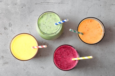 Photo of Glasses with delicious detox smoothies on light background, top view