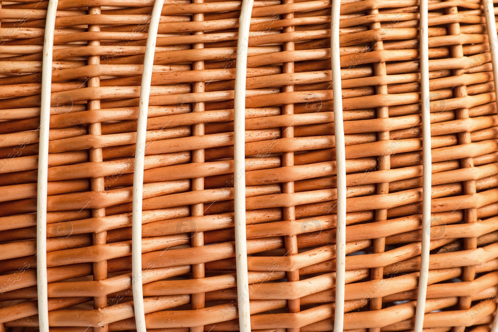 Photo of Handmade wicker basket made of natural material as background, closeup view