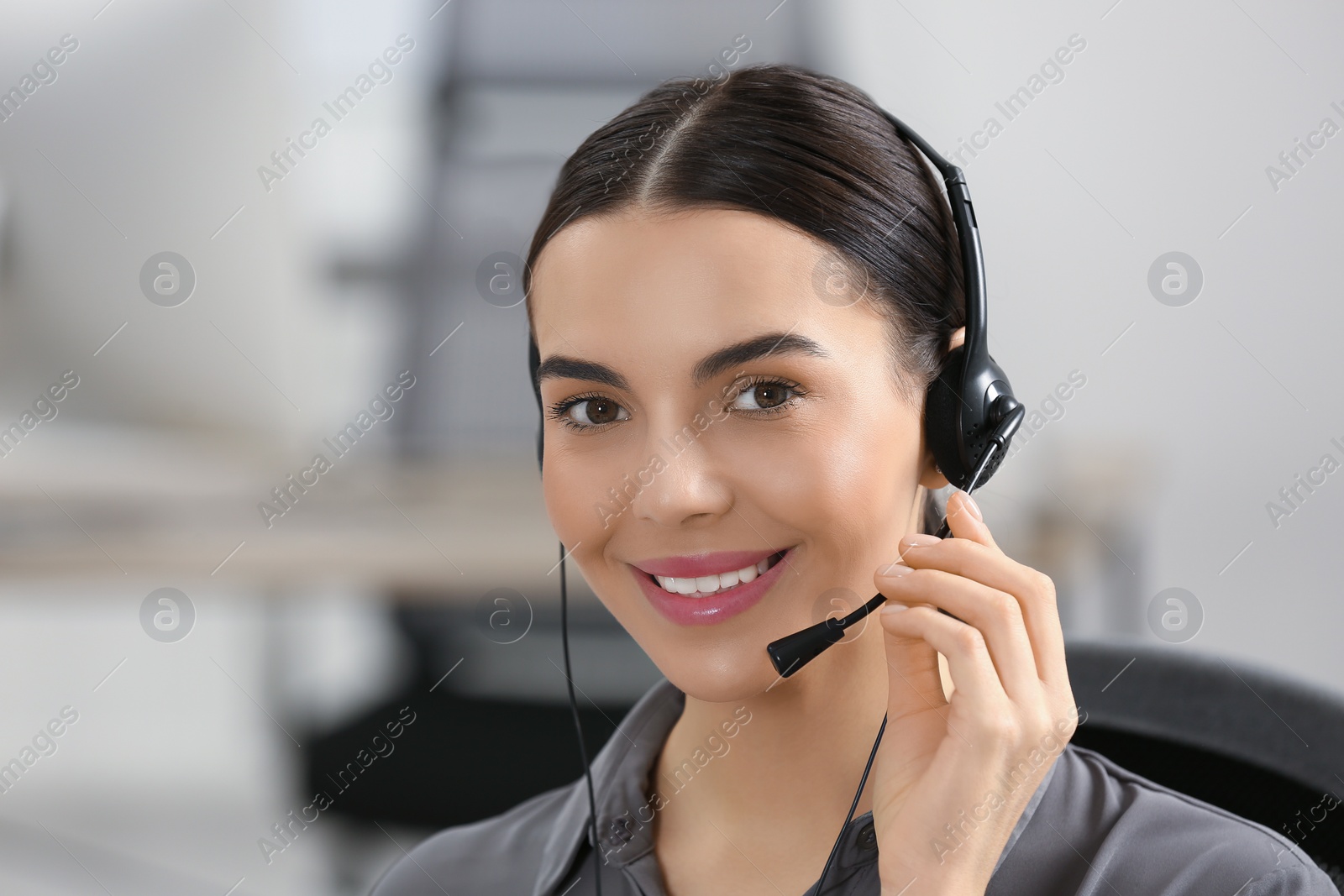 Photo of Hotline operator with headset working in office