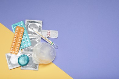 Photo of Contraceptive pills, condoms and thermometer on color background, flat lay with space for text. Choice of birth control method