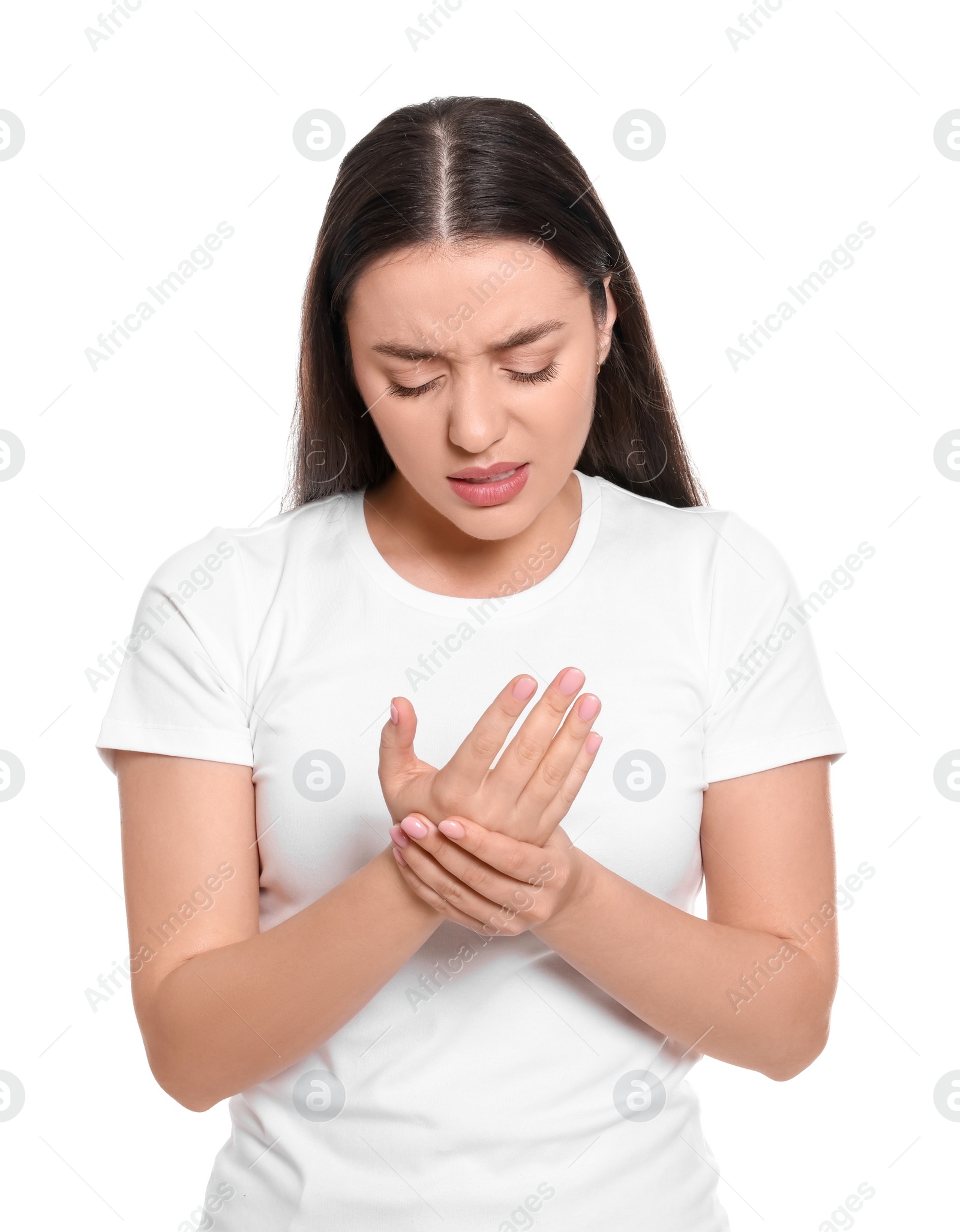 Photo of Young woman suffering from pain in hands on white background. Arthritis symptoms