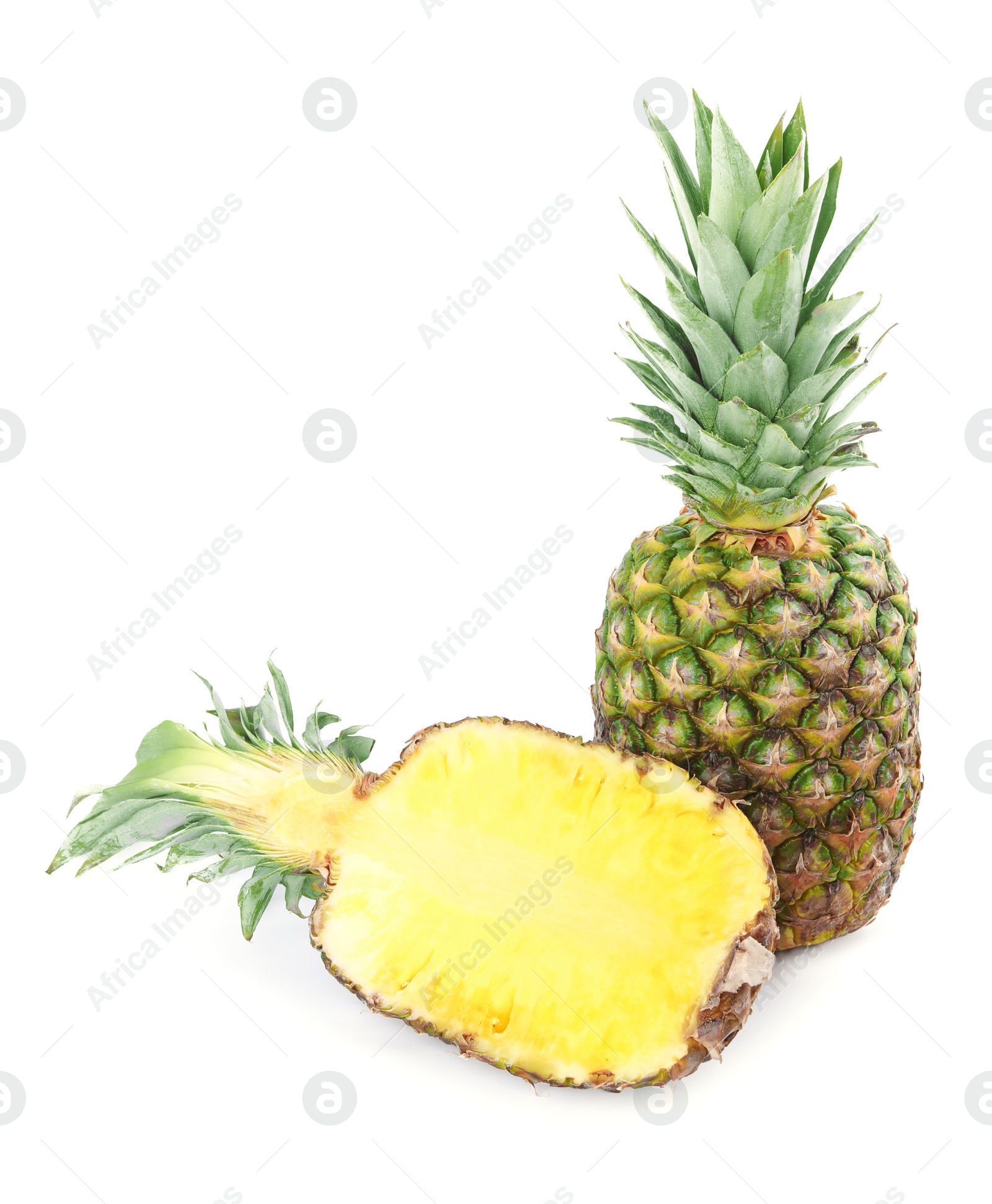 Photo of Whole and cut ripe pineapples isolated on white