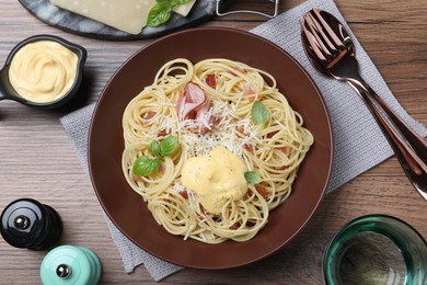 Photo of Delicious spaghetti with cheese sauce and meat served on wooden table, flat lay