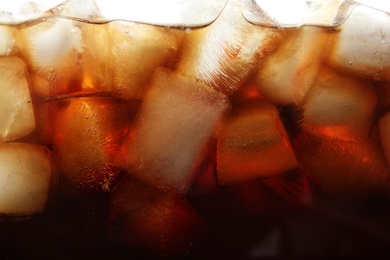 Closeup view of tasty refreshing cola with ice cubes