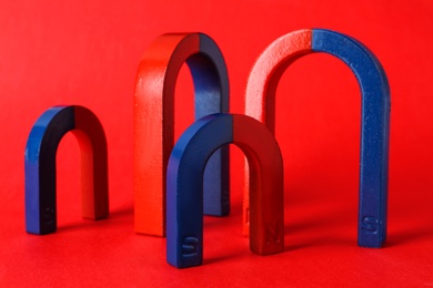 Photo of Red and blue horseshoe magnets on color background