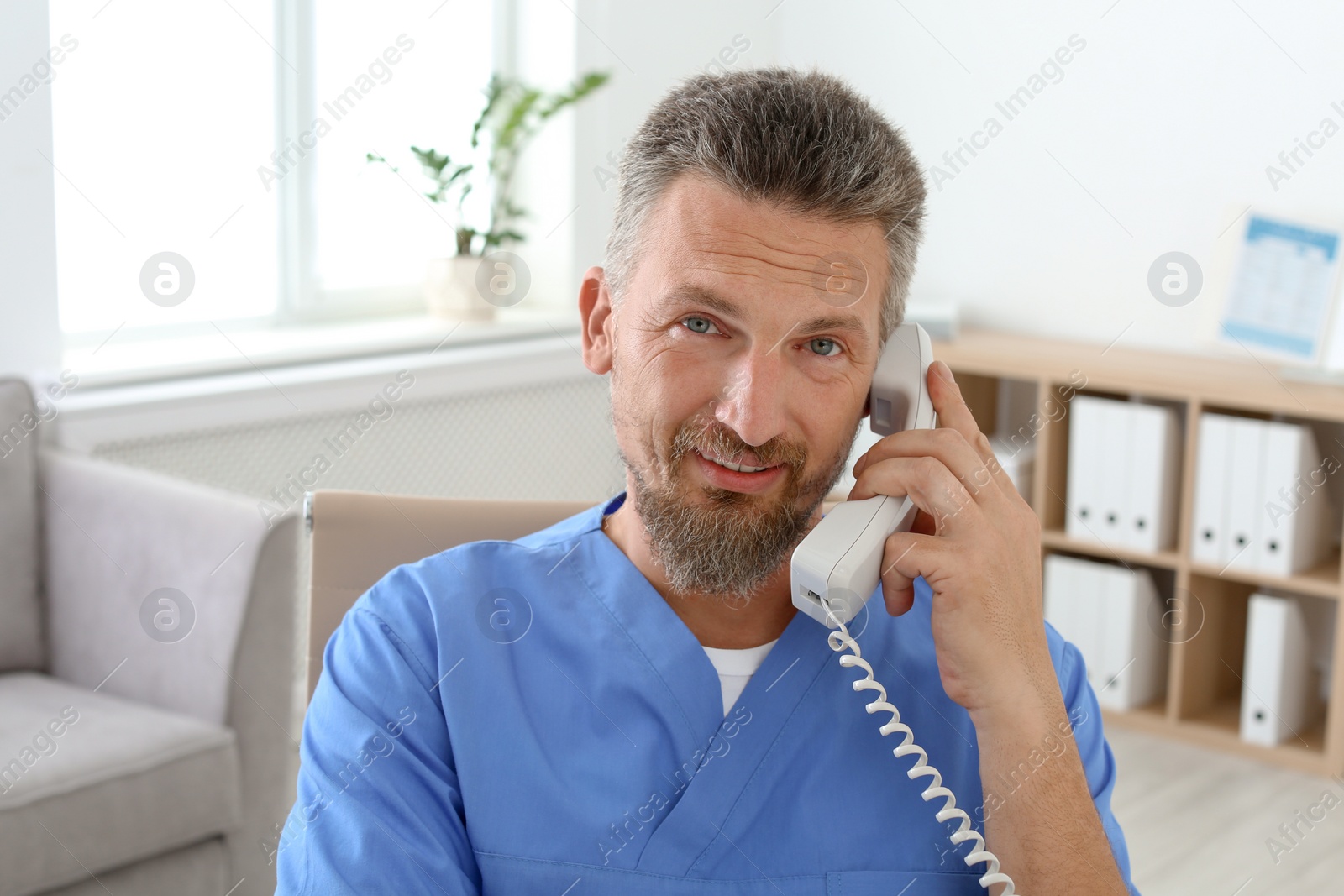 Photo of Male medical assistant working in clinic. Health care service