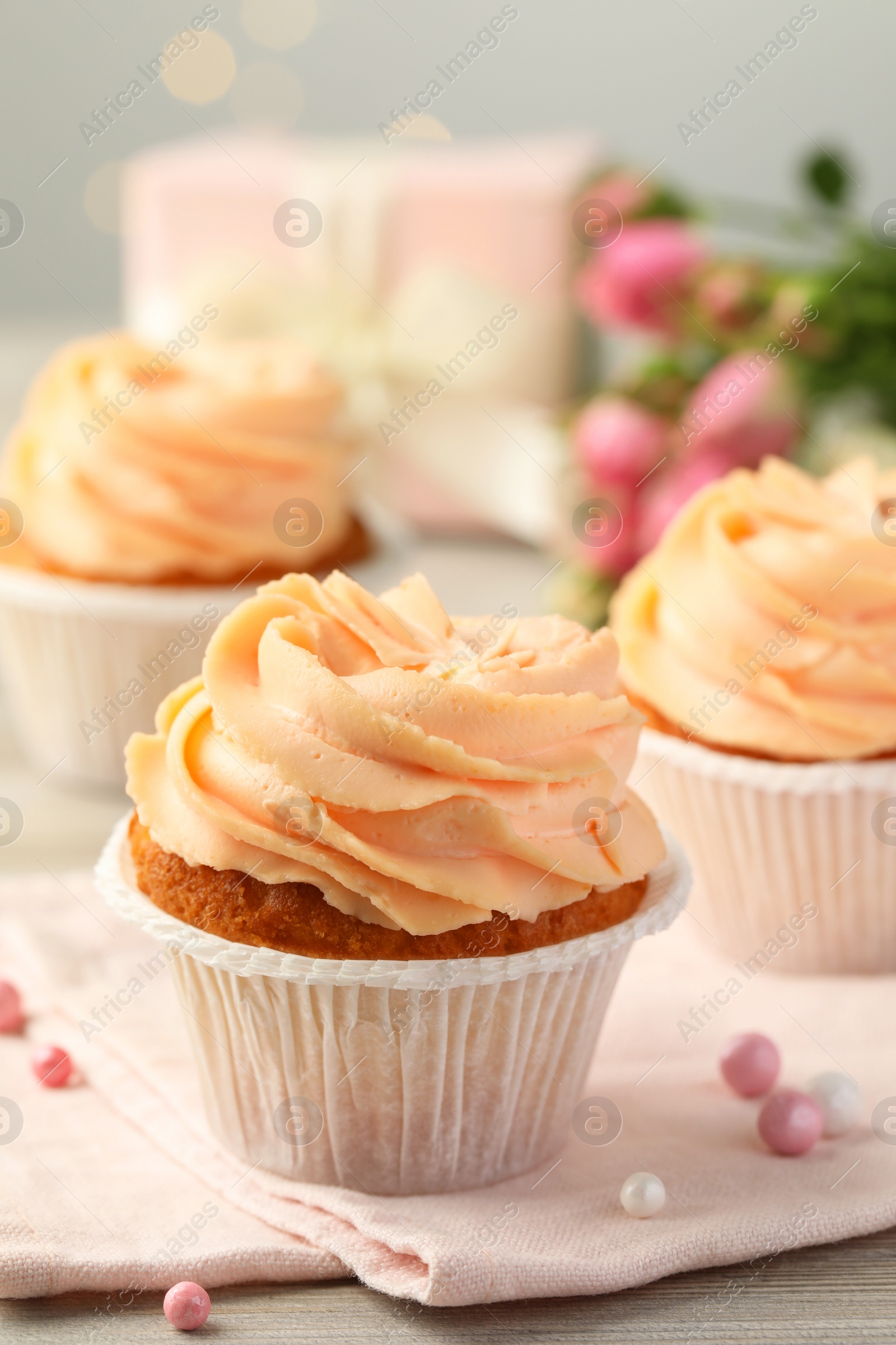 Photo of Tasty cupcake with cream on table, closeup view