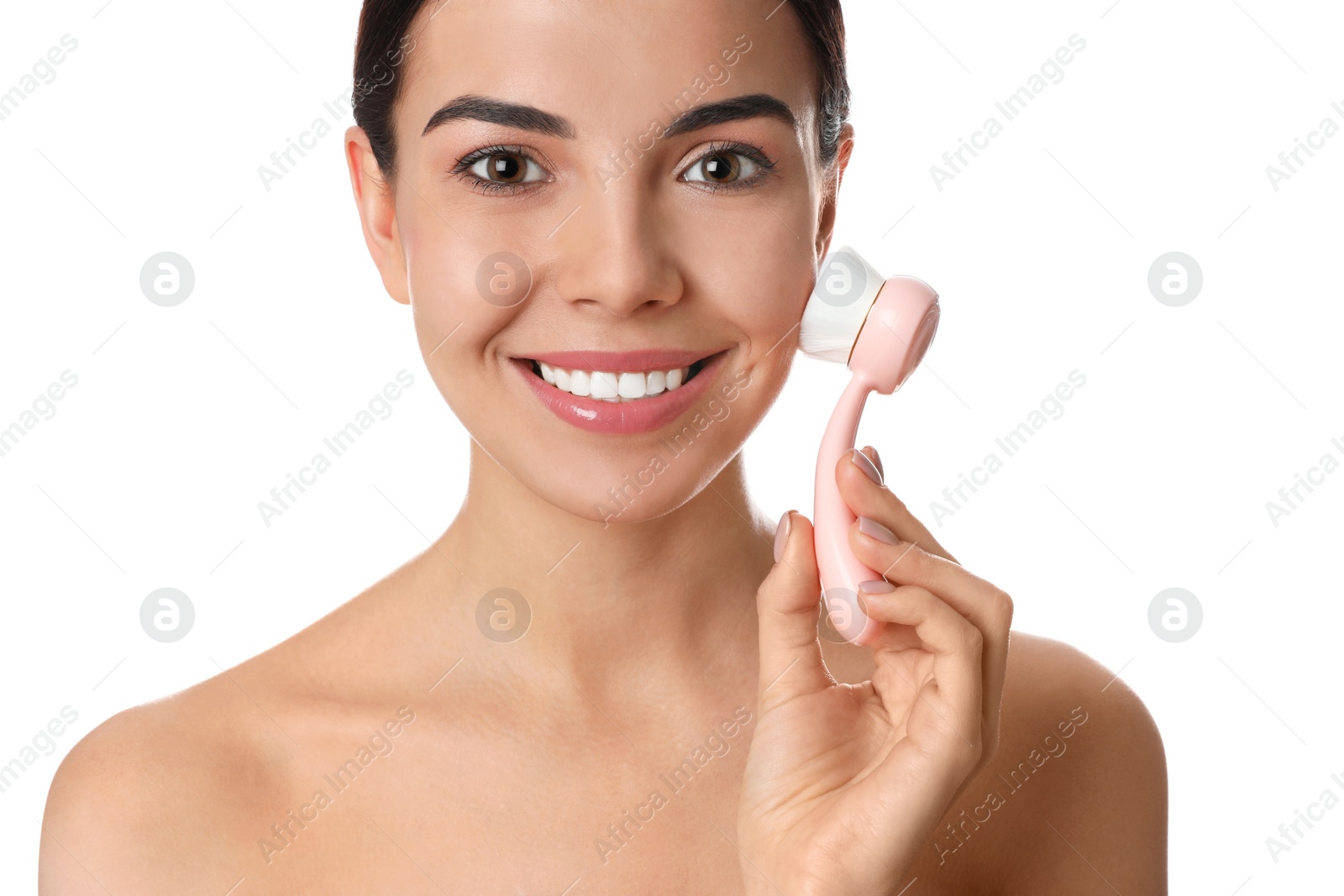 Photo of Young woman using facial cleansing brush on white background. Washing accessory