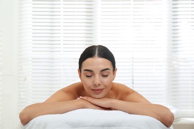 Photo of Beautiful young woman relaxing in spa salon