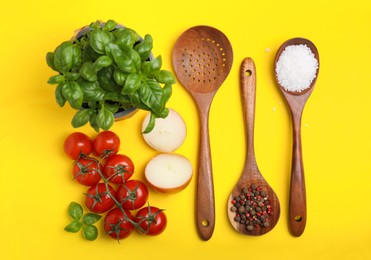 Photo of Flat lay composition with cooking utensils and fresh ingredients on yellow background