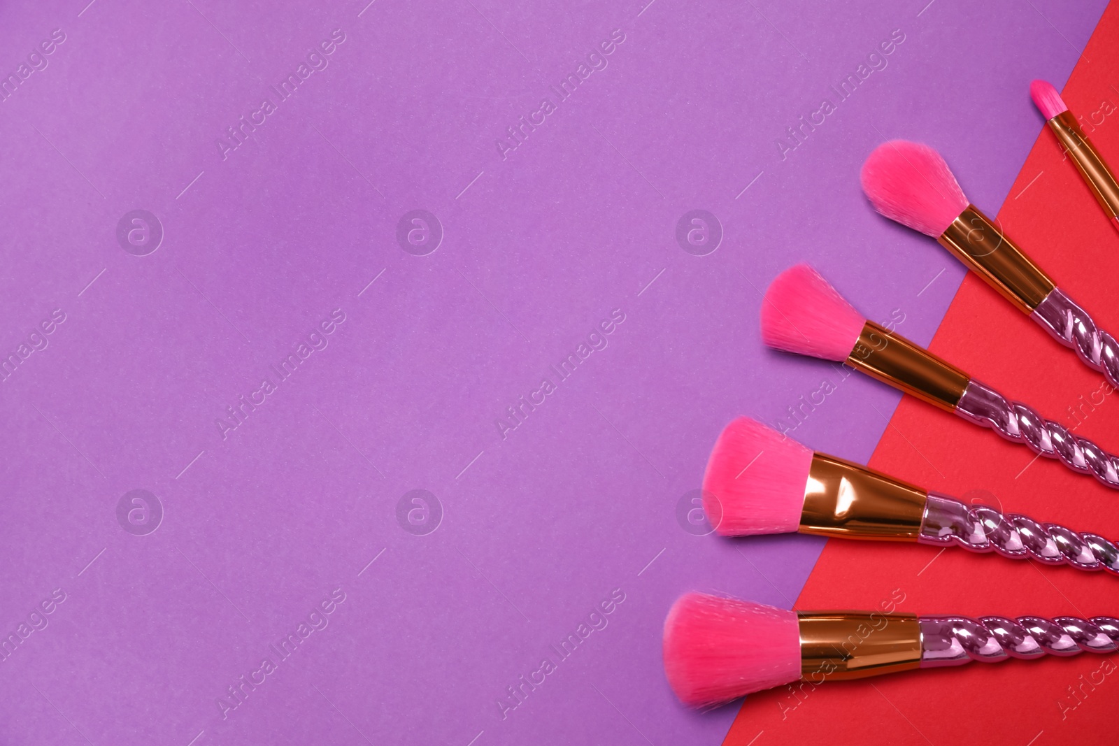 Photo of Set of makeup brushes on color background, flat lay. Space for text