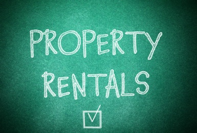 Image of Text Property Rentals and check mark on green chalkboard