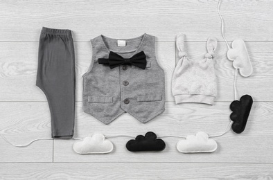 Photo of Flat lay composition with stylish child clothes on wooden background