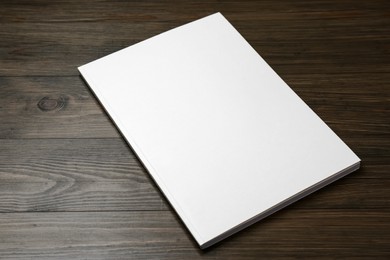 Photo of Blank paper brochure on wooden table. Mockup for design