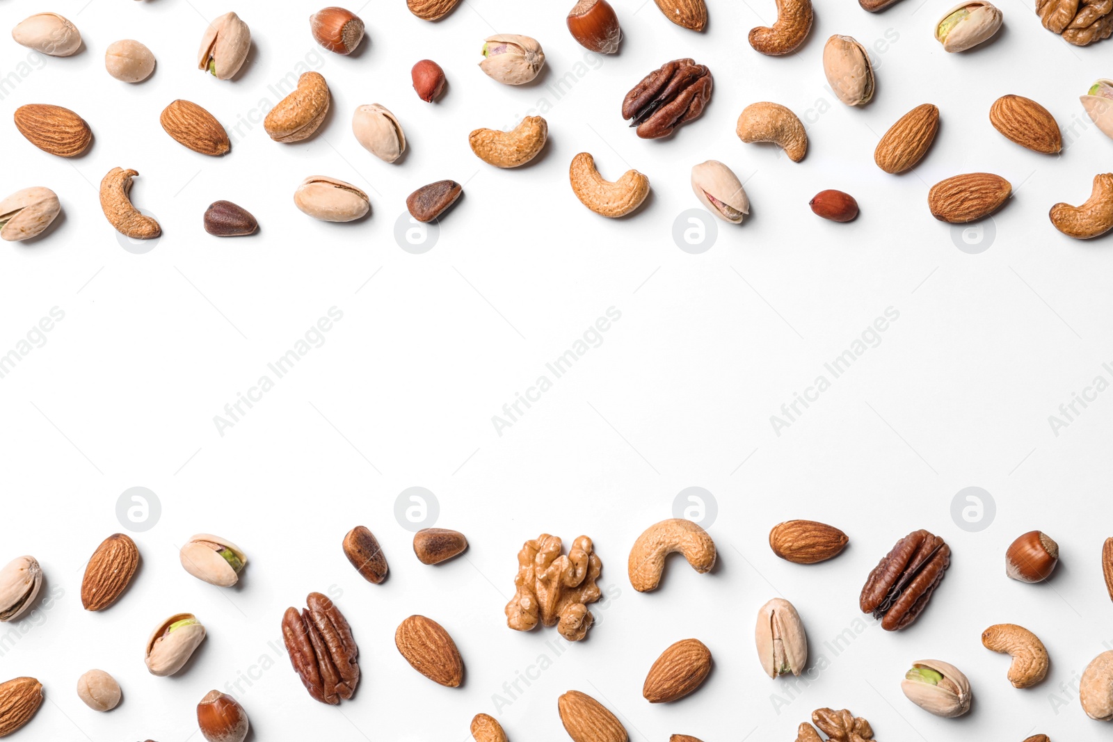 Photo of Composition with organic mixed nuts on white background, top view. Space for text