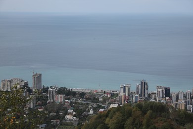 Photo of Picturesque view of city, green trees and sea