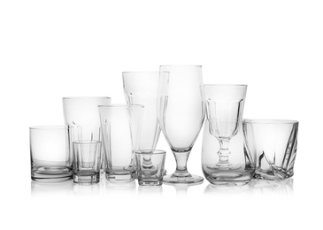 Photo of Set of empty glasses for different drinks on white background