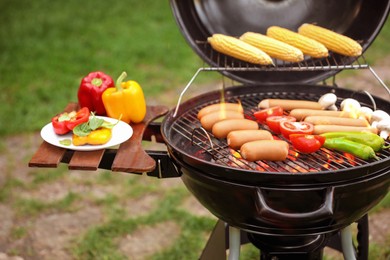 Image of Barbecue grill with tasty fresh food outdoors