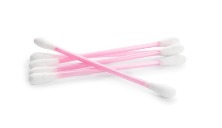 Pink plastic cotton swabs on white background