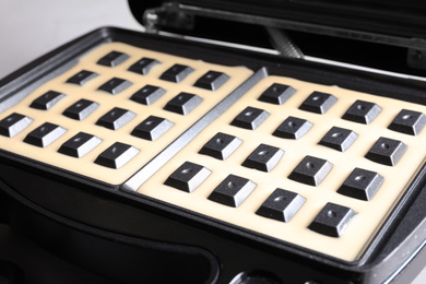 Photo of Modern Belgian waffle maker with dough, closeup