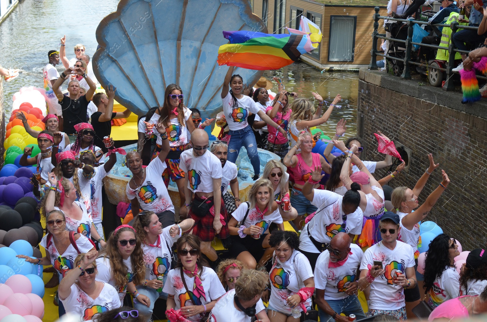 Photo of AMSTERDAM, NETHERLANDS - AUGUST 06, 2022: Many people in boat at LGBT pride parade on river