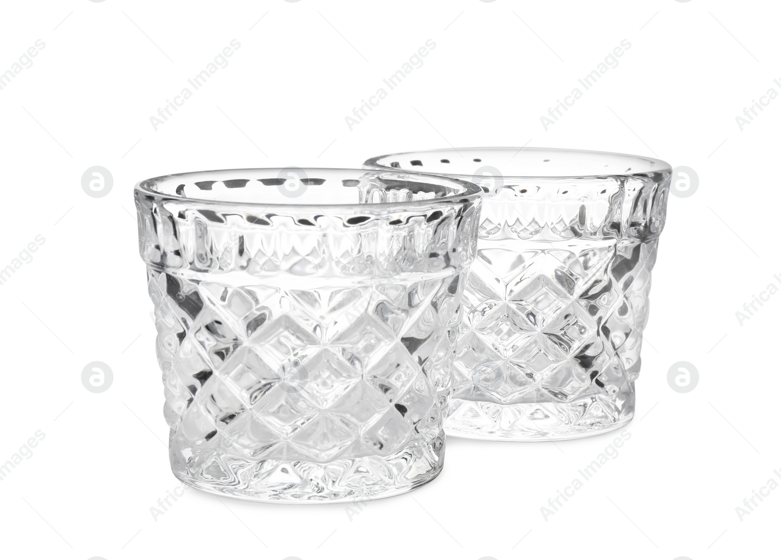 Photo of Two modern glass candle holders on white background