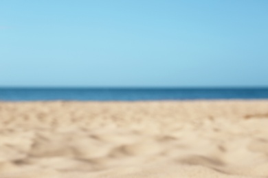 Photo of Blurred view of beautiful sandy beach and sea on sunny day. Summer vacation