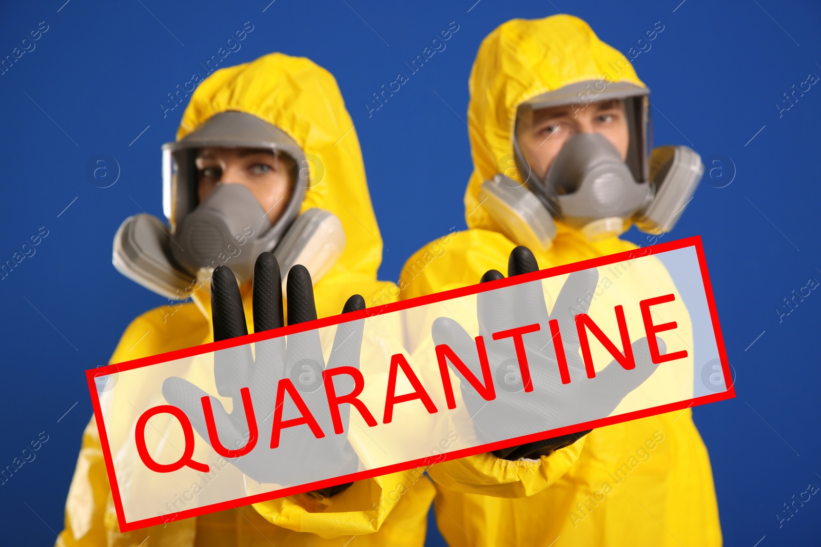 Image of Quarantine during coronavirus outbreak. Man and woman in chemical protective suits making stop gesture against blue background