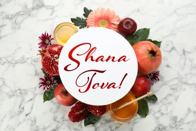 Flat lay composition with Rosh Hashanah holiday attributes and card on white marble table 