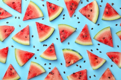 Photo of Flat lay composition with slices and seeds of watermelon on color background