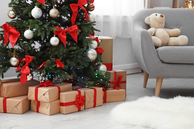 Beautiful Christmas tree with gifts in decorated living room