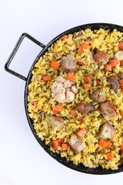 Photo of Delicious pilaf with meat, carrot and garlic on white background, top view