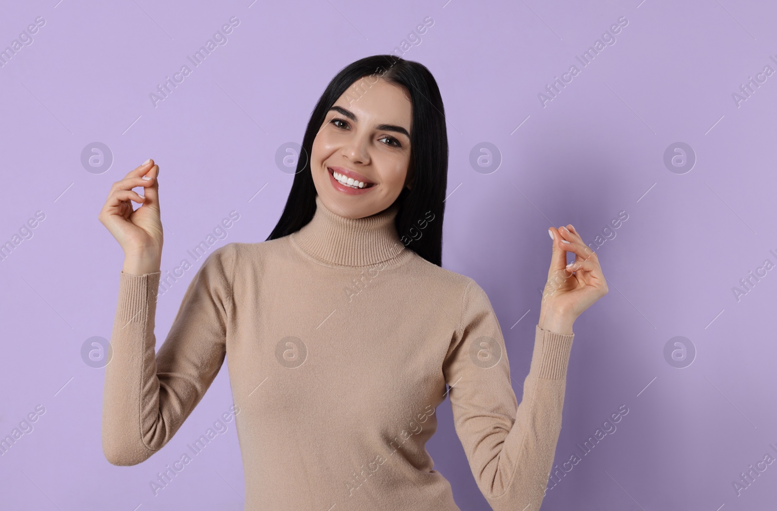 Photo of Young woman snapping fingers on violet background