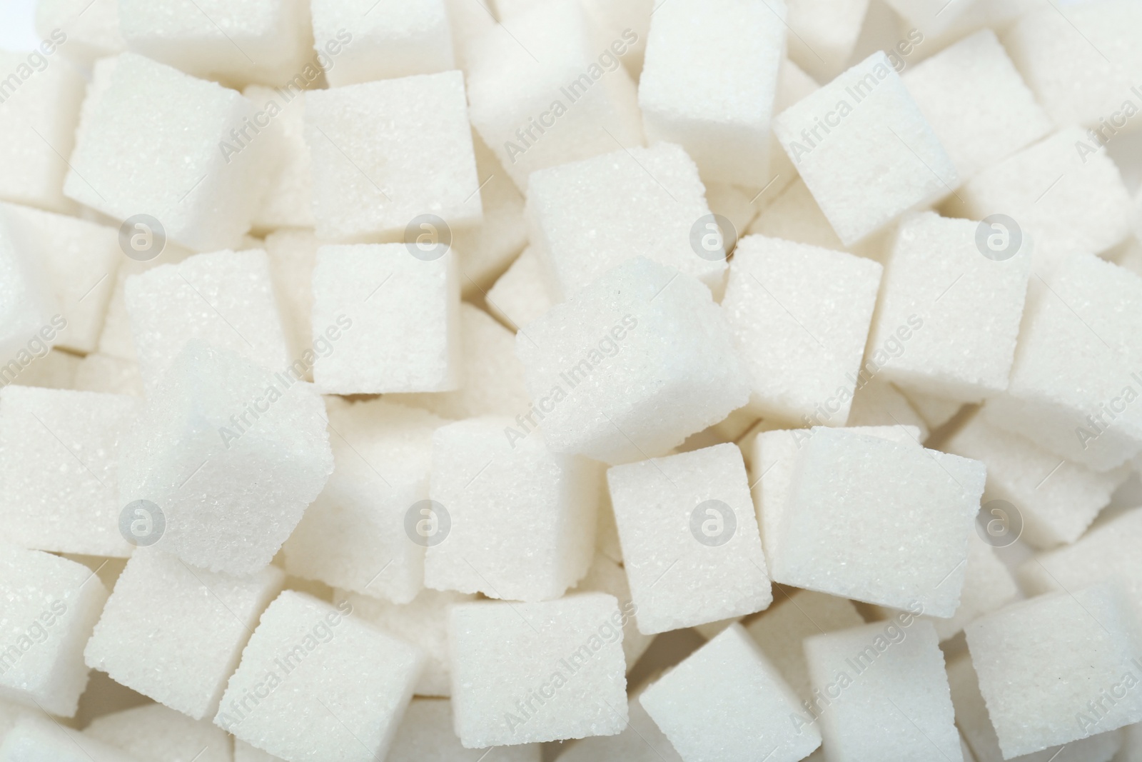 Photo of White sugar cubes as background, top view