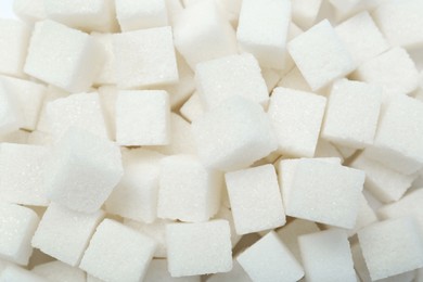 Photo of White sugar cubes as background, top view