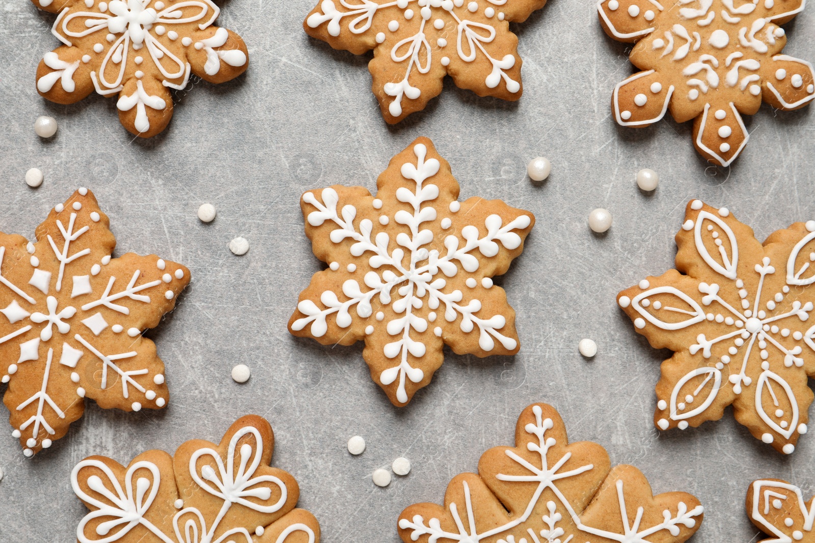 Photo of Tasty Christmas cookies on light grey table, flat lay