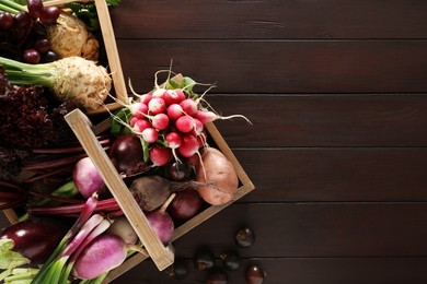 Different fresh ripe vegetables on wooden table, flat lay. Space for text