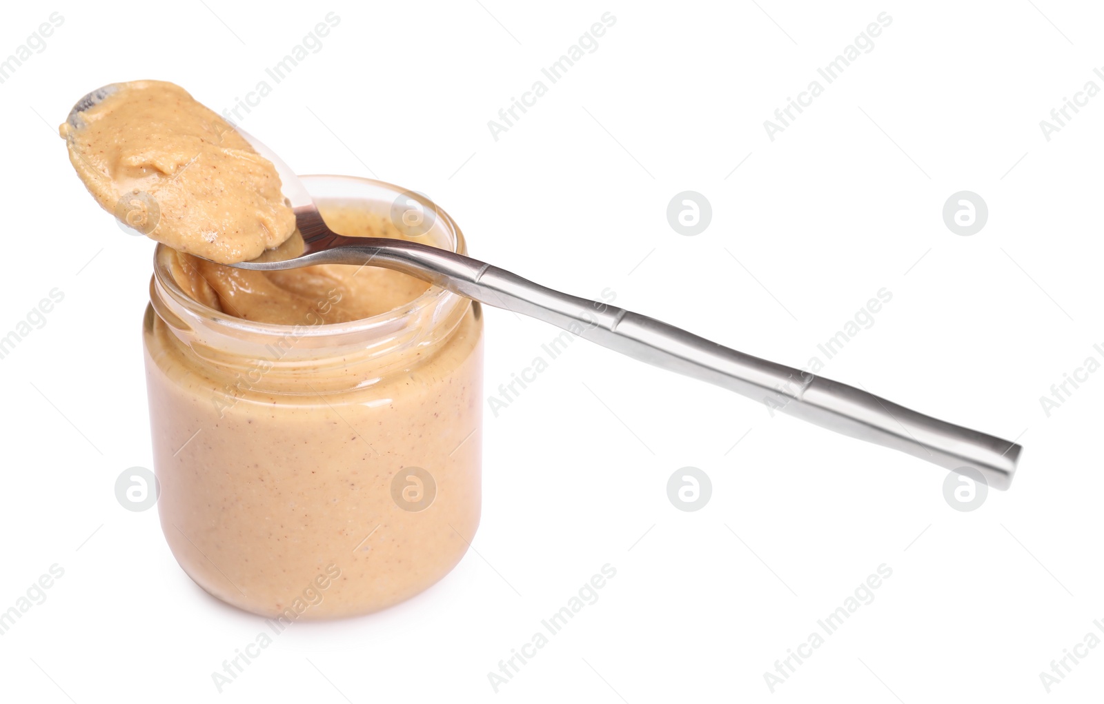 Photo of Tasty nut paste in jar and spoon isolated on white