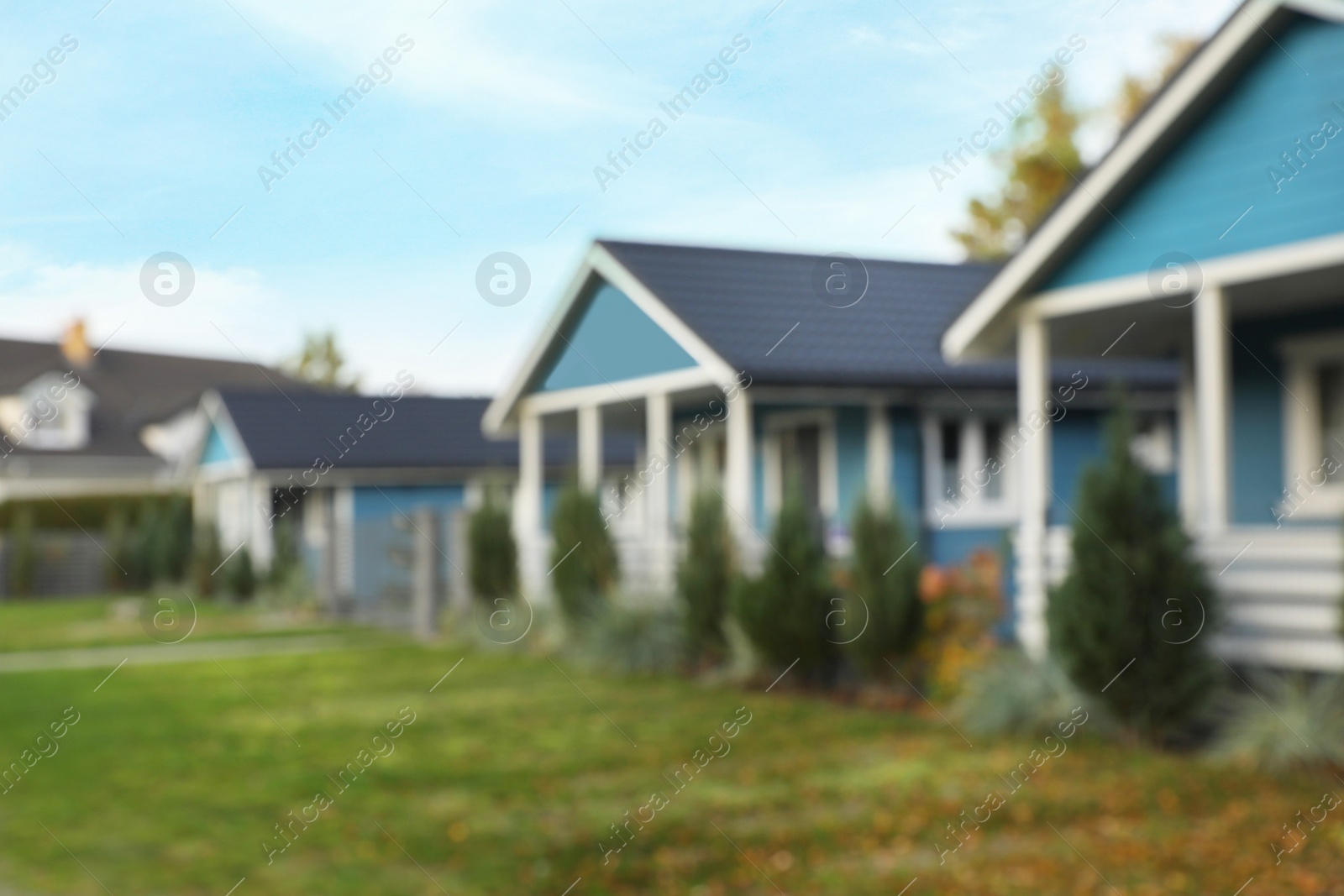 Photo of Blurred view of beautiful light blue houses outdoors. Real estate