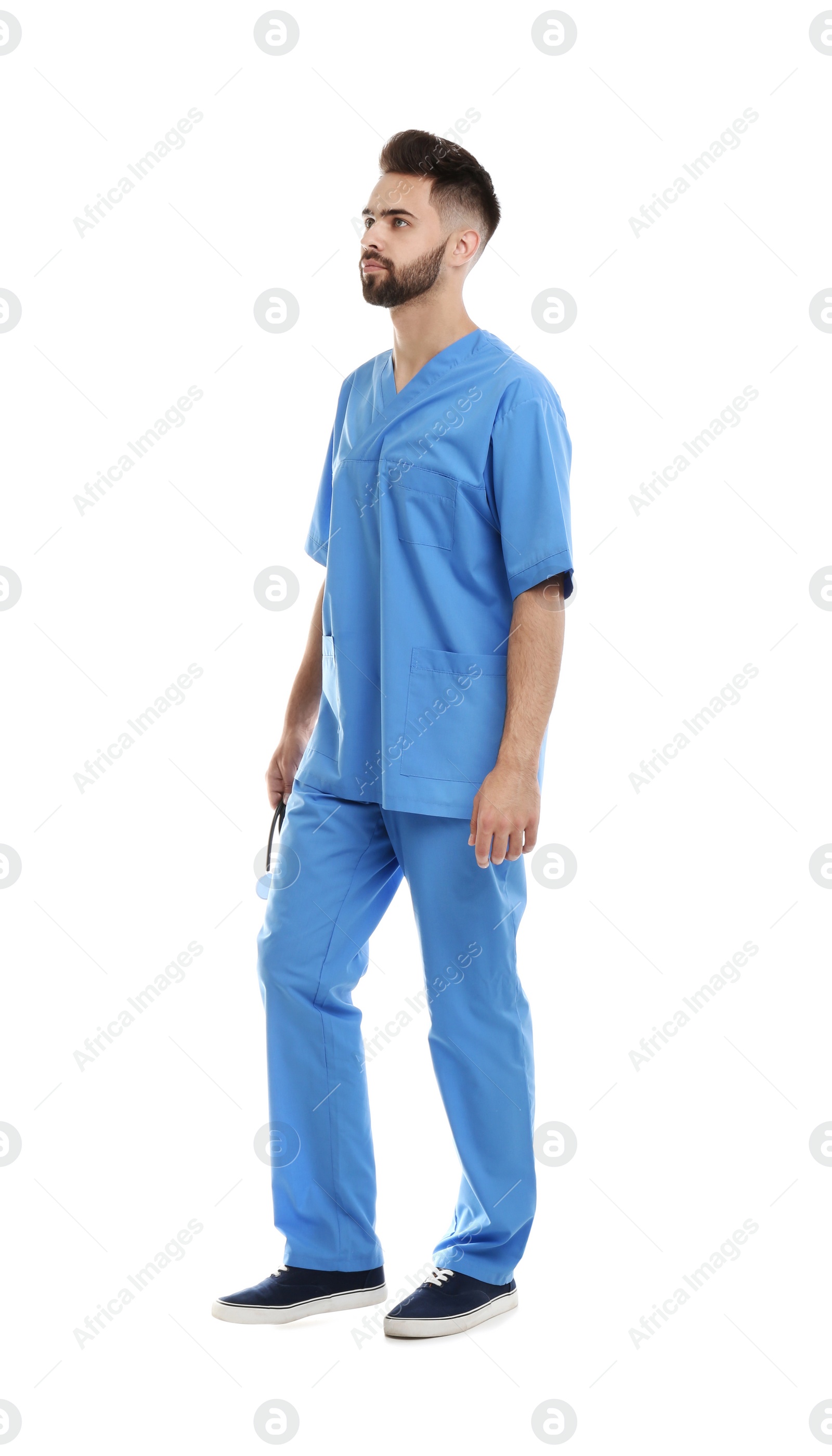 Photo of Young male doctor in uniform isolated on white