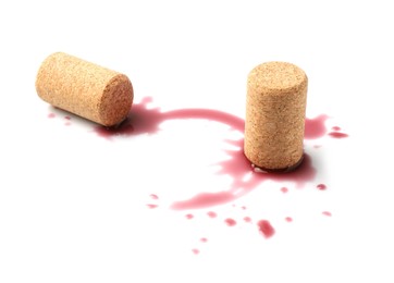 Photo of Bottle corks with wine stains on white background