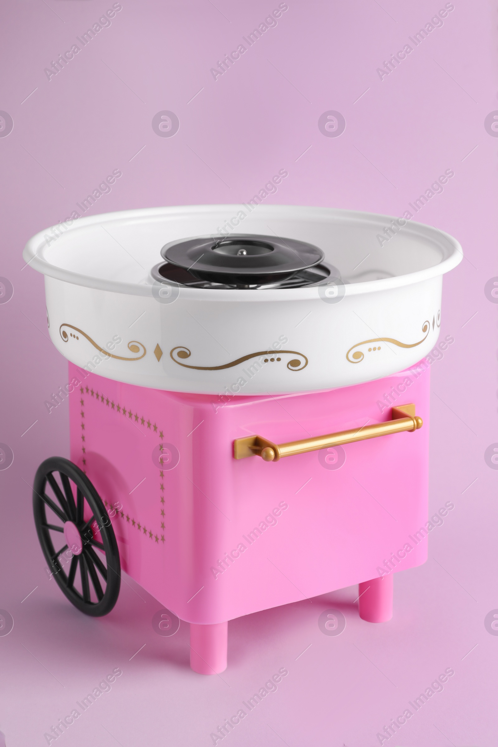 Photo of Portable candy cotton machine on violet background