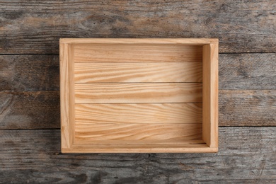 Photo of Empty crate on wooden background, top view