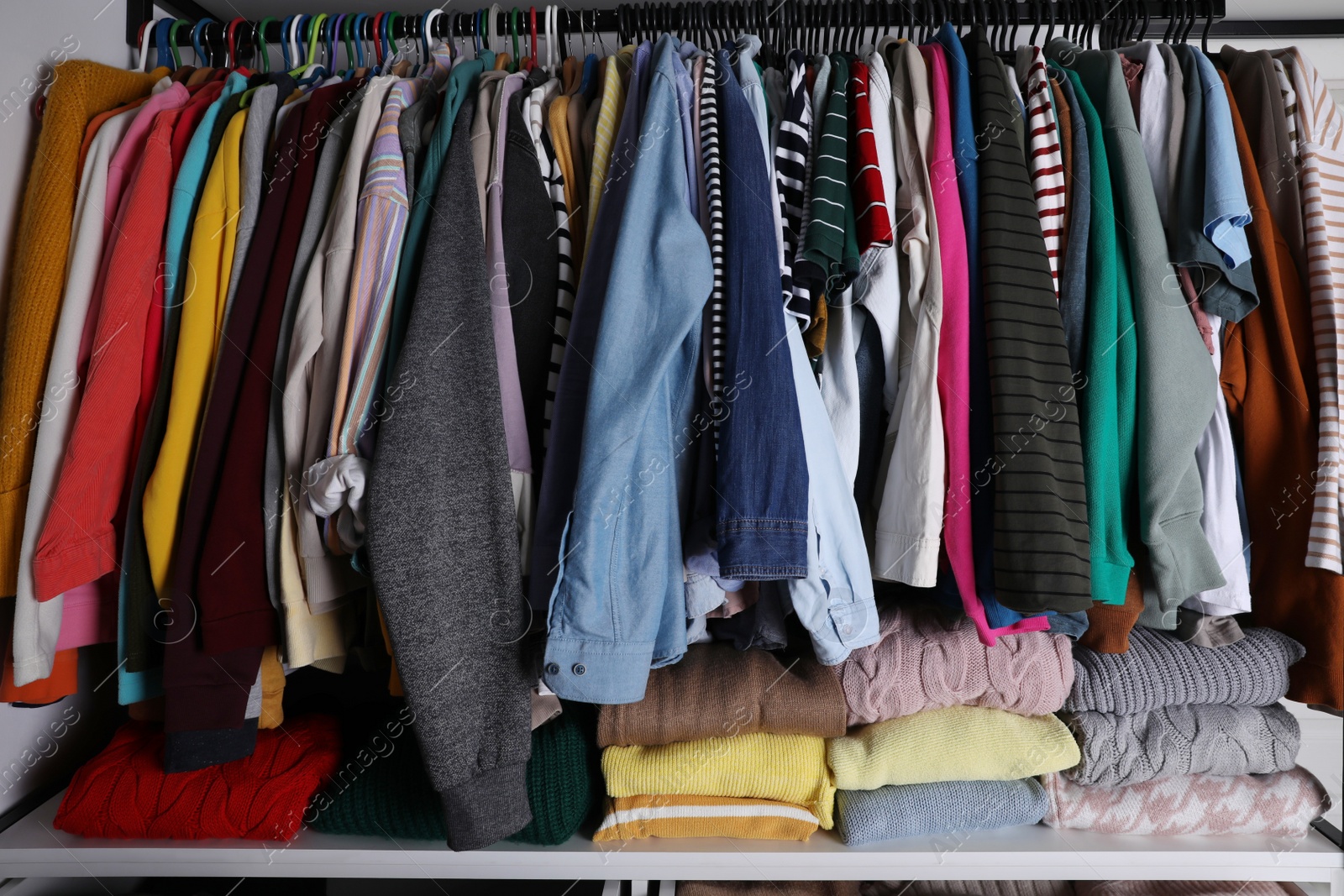 Photo of Wardrobe closet with different stylish clothes. Fast fashion