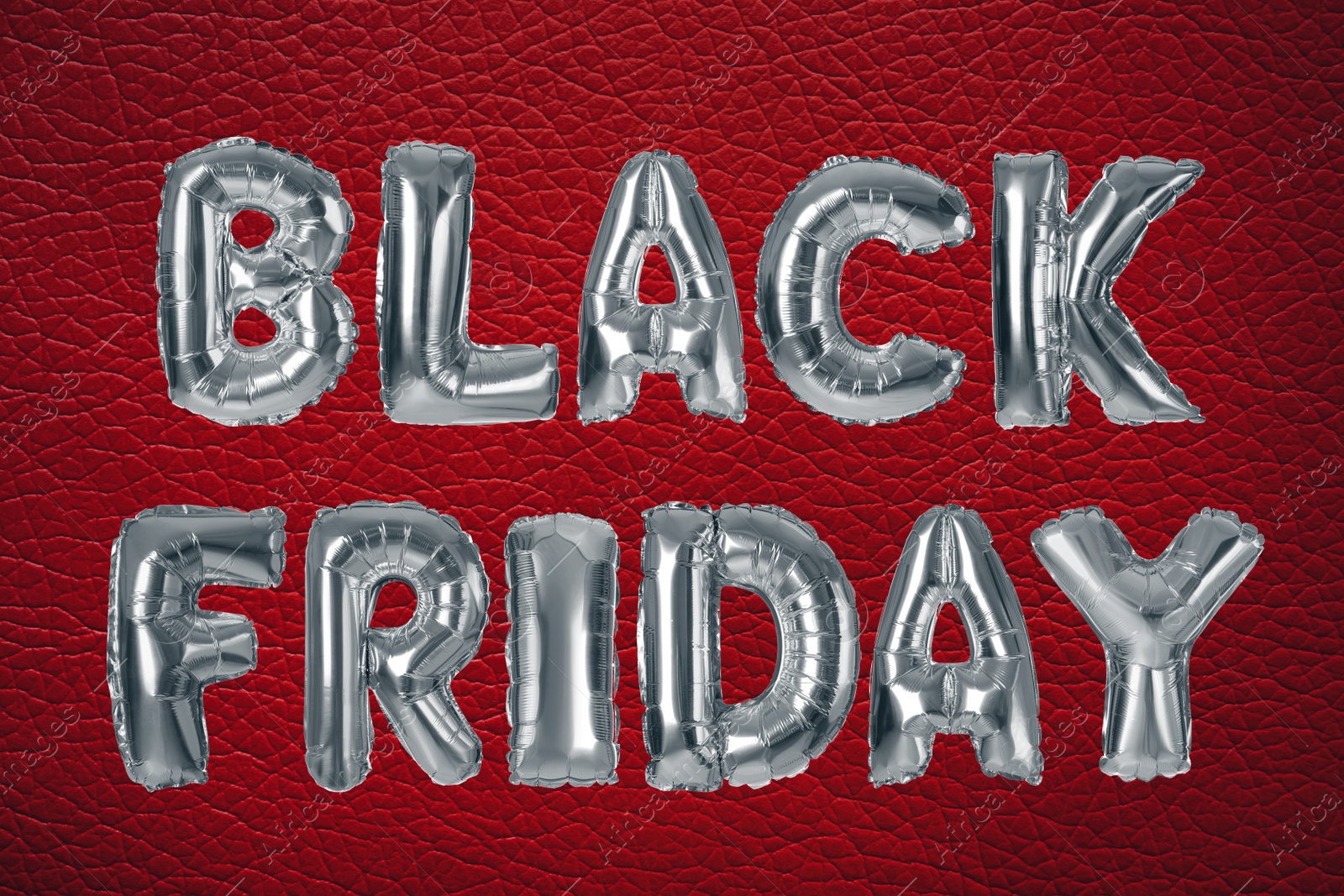 Image of Phrase BLACK FRIDAY made of foil balloon letters on red background