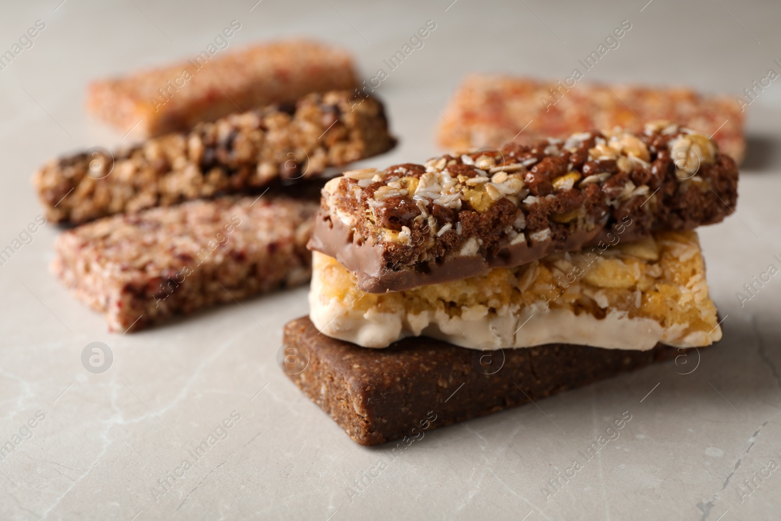 Photo of Tasty protein bars on grey table. Space for text