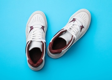 Photo of Pair of stylish shoes on blue background, top view