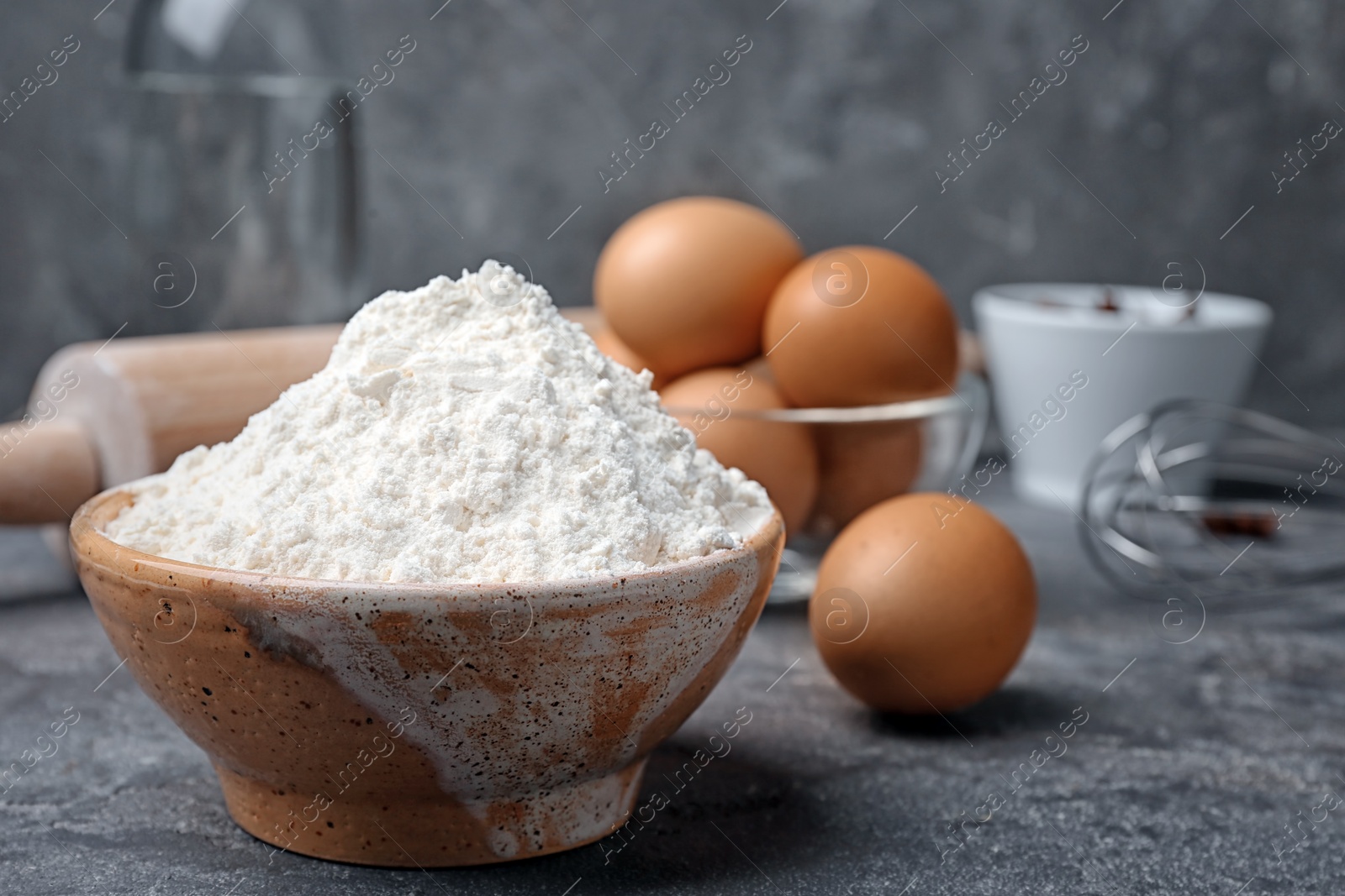 Photo of Bowl with flour on table