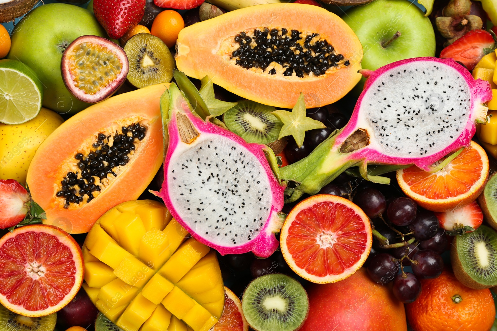 Photo of Many different delicious exotic fruits as background, top view