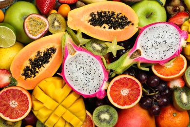 Many different delicious exotic fruits as background, top view